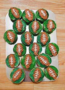 A platter with football cupcakes on it.