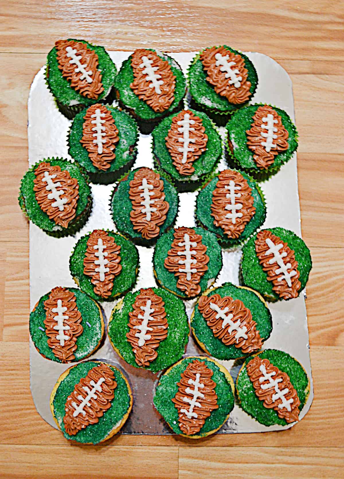  A platter with football cupcakes on it.