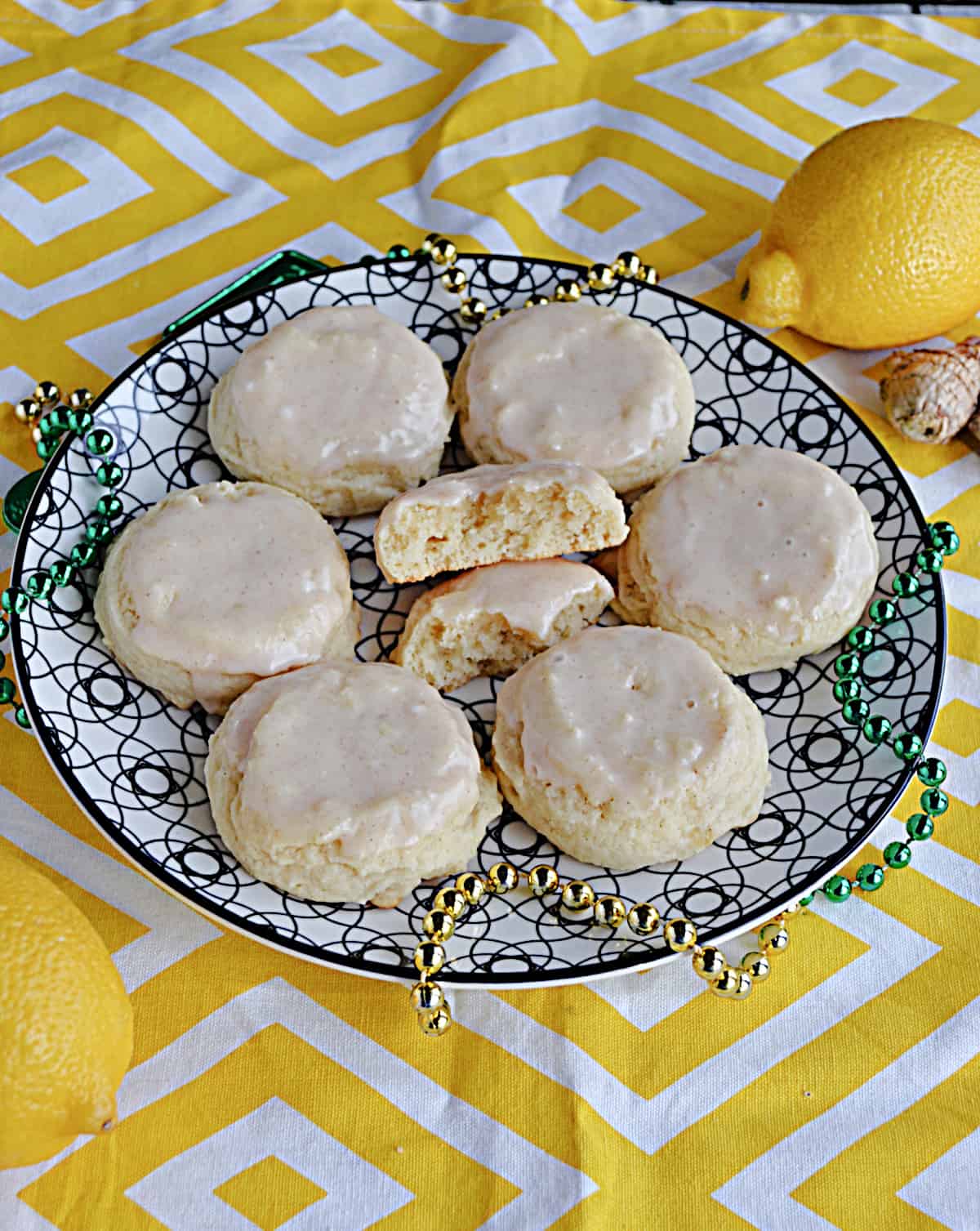 A plate of lemon ginger cookies with one cookie broken in half.
