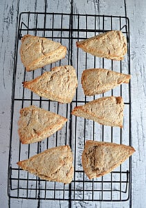 A cooling rack with 8 scones on it.