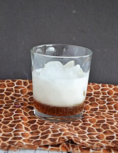 A glass layered with brown sugar syrup and cold milk.
