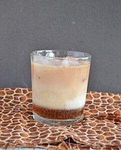 A glass layered with brown sugar syrup, cold milk, and black tea.