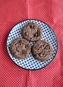 A plate with three chocolate Nutella cookies.
