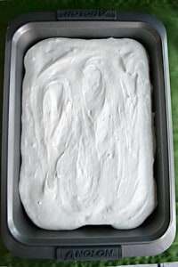 A cake with whipped cream frosting.