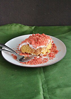 A slice of Strawberry Scooter Crunch Cake on a plate.