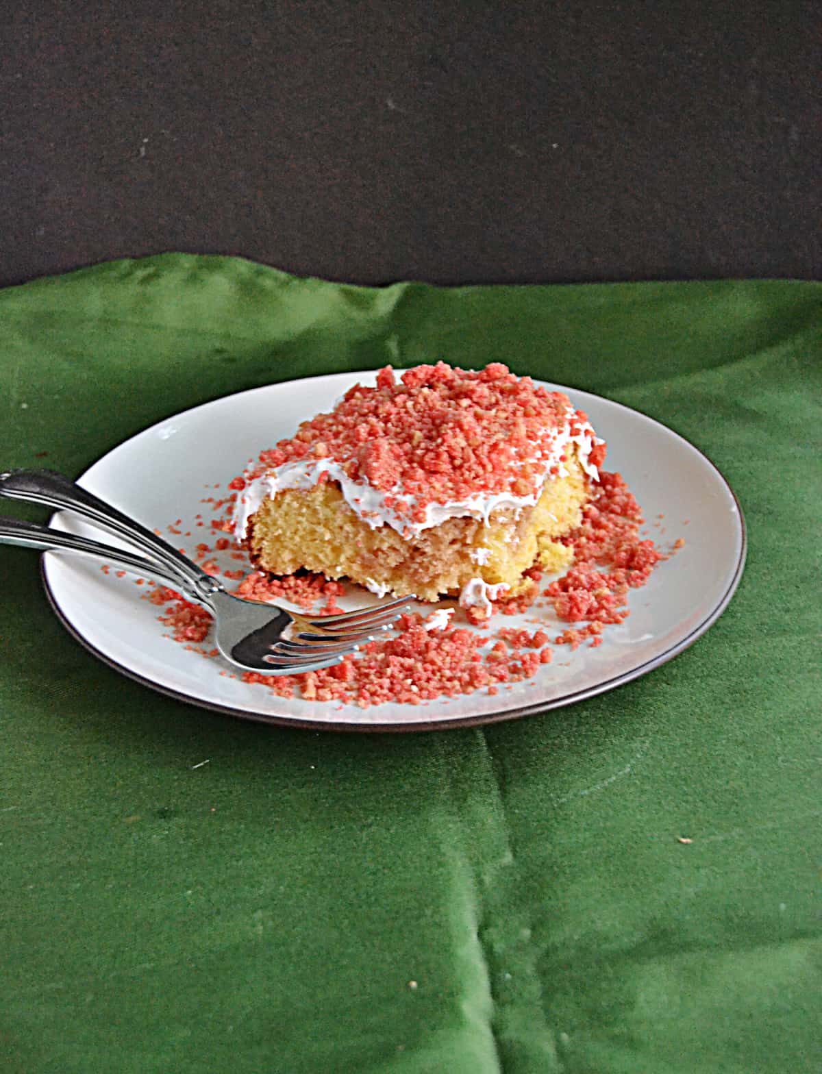 A slice of Strawberry Scooter Crunch Cake on a plate.