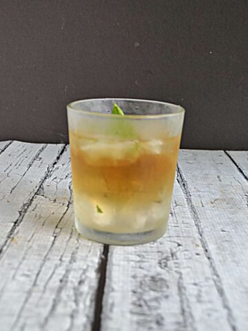 A glass with bourbon over crushed ice in it.