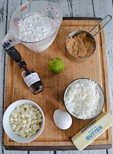 A cutting board with ingredients to make coconut lime bars.