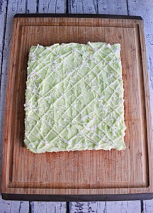Cookie bars frosted with lime frosting and a white chocolate drizzle.