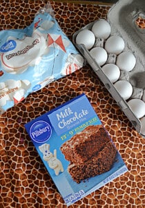 A box of brownie mix, a bag of marshmallows, and a container of eggs.
