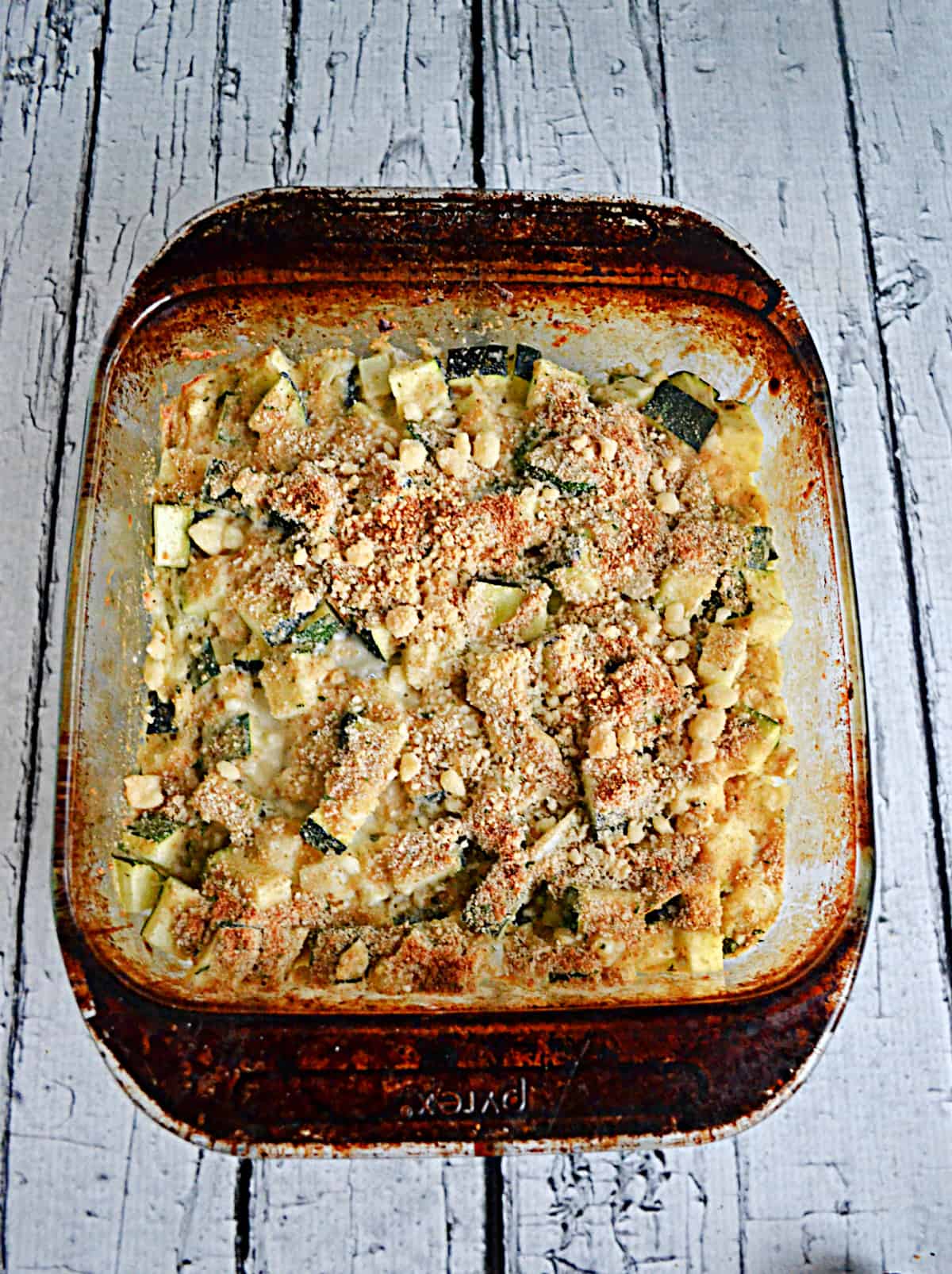 A dish of zucchini with toasted breadcrumbs on top.