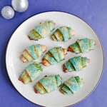 A plate of Rugelach with blue sprinkles on them.