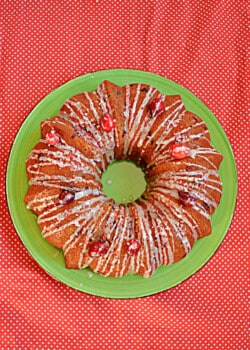 A plate with a cranberry Bundt cake on tp.