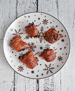 A plate of Bacon wrapped meatballs with toothpicks in them.