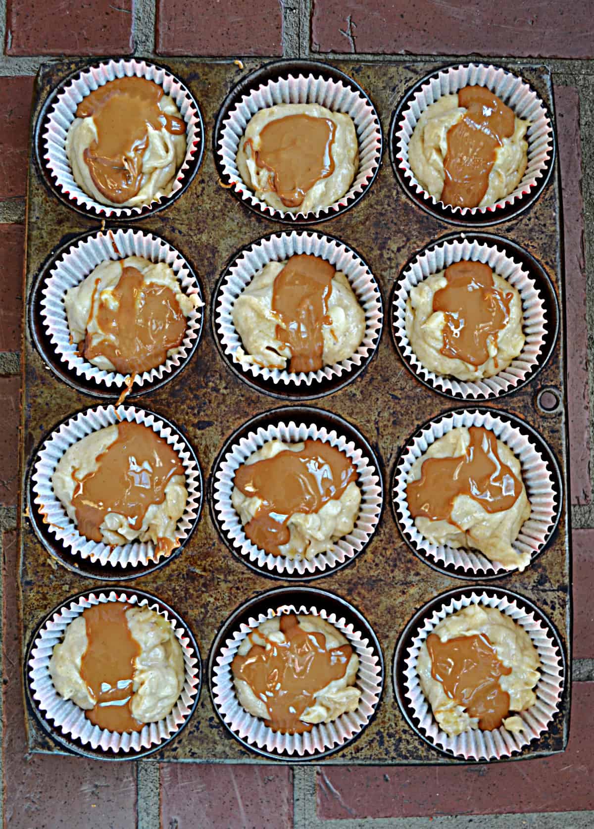 A tin of muffins swirled with Biscoff spread.