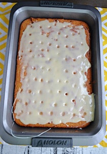 A poke cake with condensed milk on top.