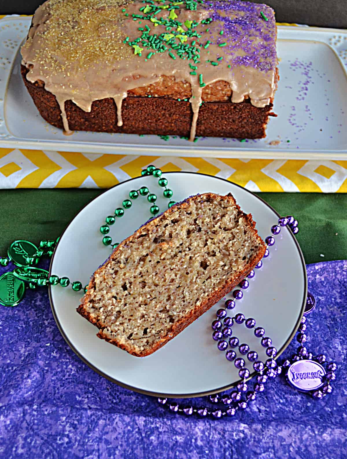 A slice of Bananas Foster Bread with green and purple beads around it.