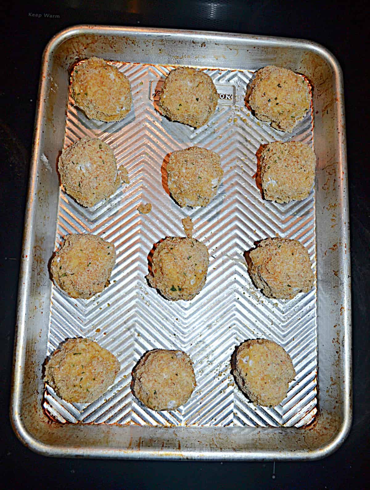 A baking sheet with sauerkraut balls on it.