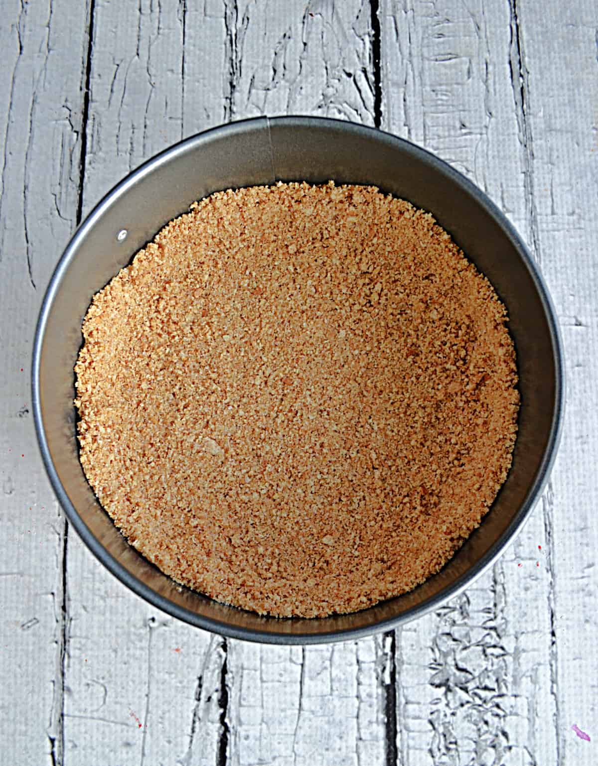 Graham cracker crust in a spring form pan.