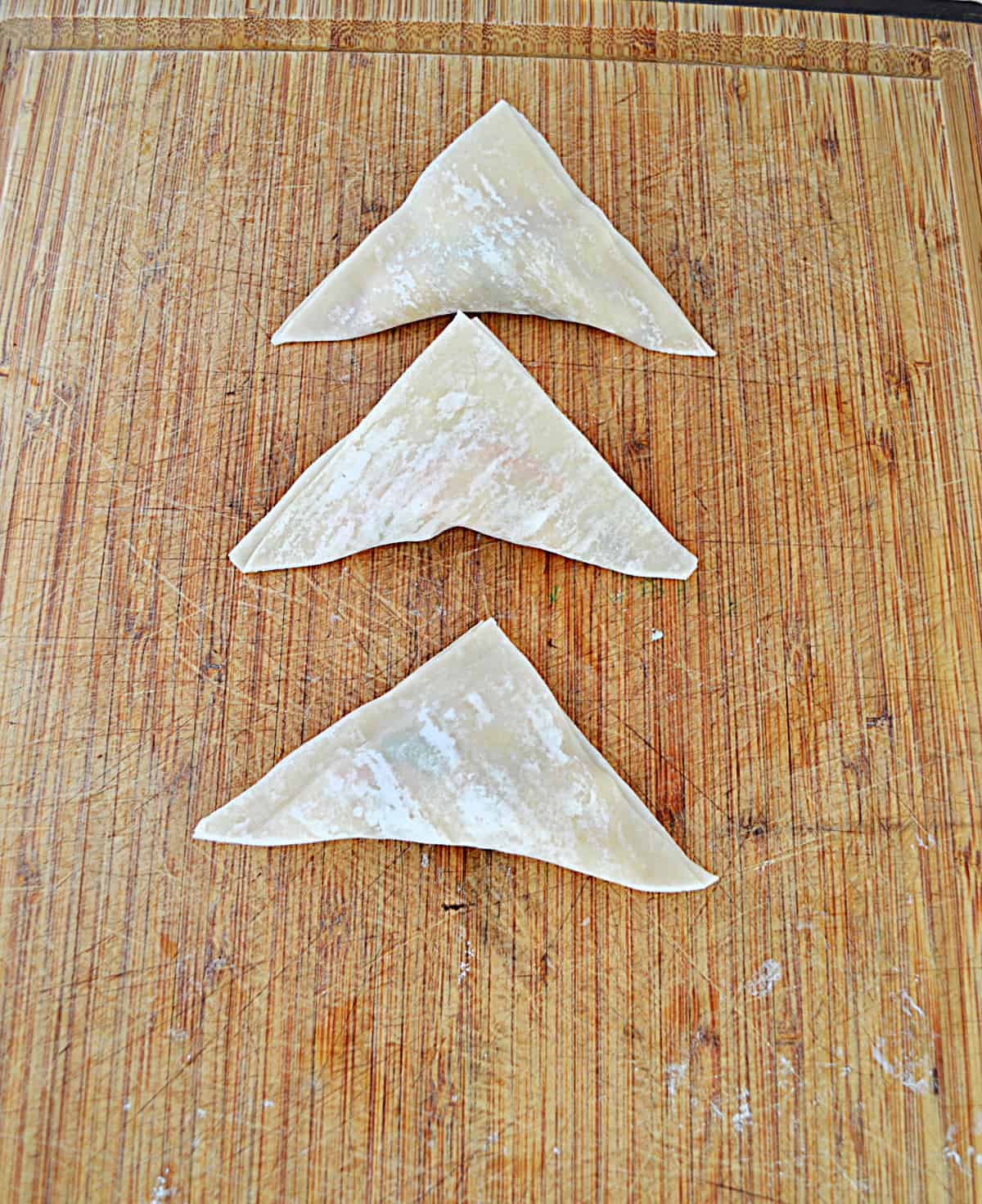 Three won tons ready for frying.