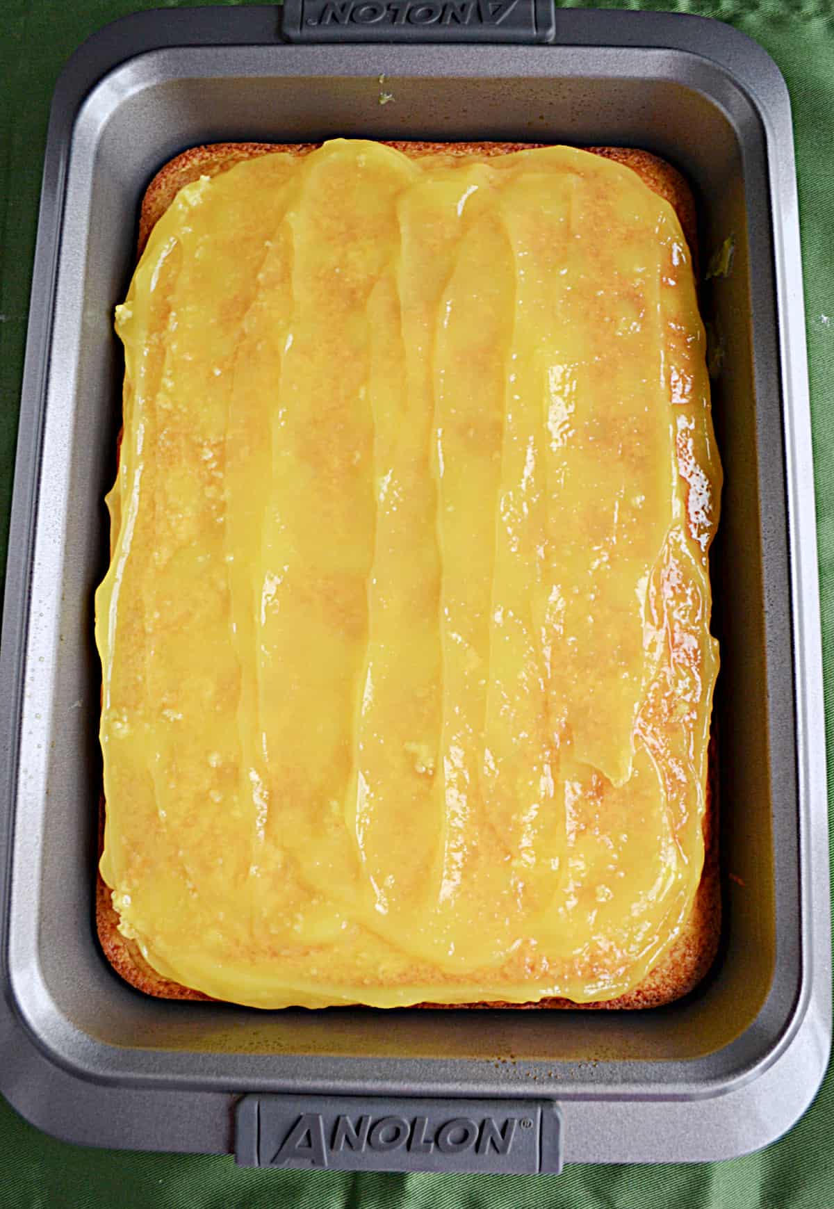 A cake with lemon pie filling on top of it.