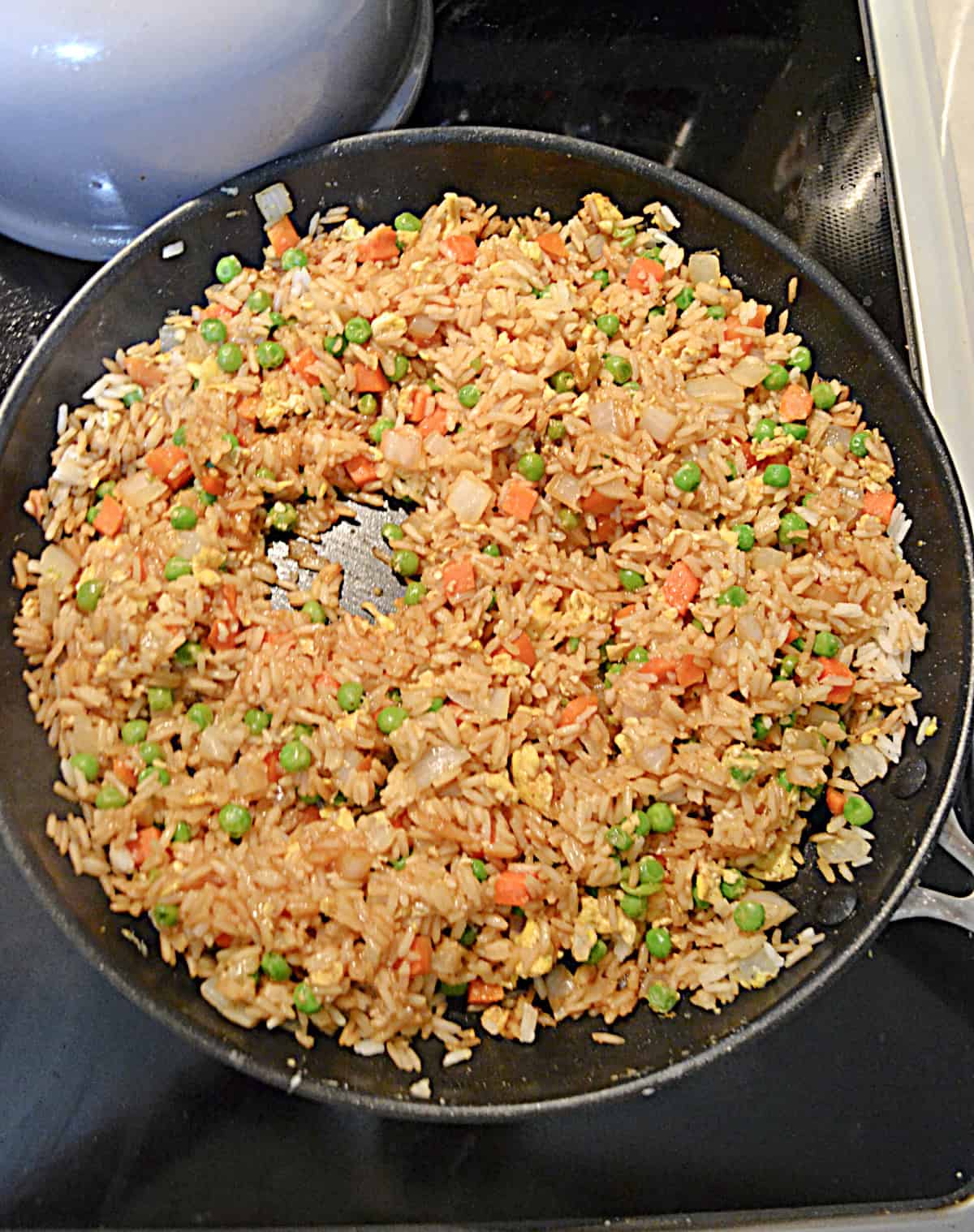 A skillet filled with fried rice.