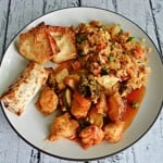 Pin Image: Text title, A plate of fried rice, baked chicken, egg roll.