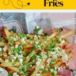 Pin Image: Text title, a close up of fries with feta and hot honey on top.