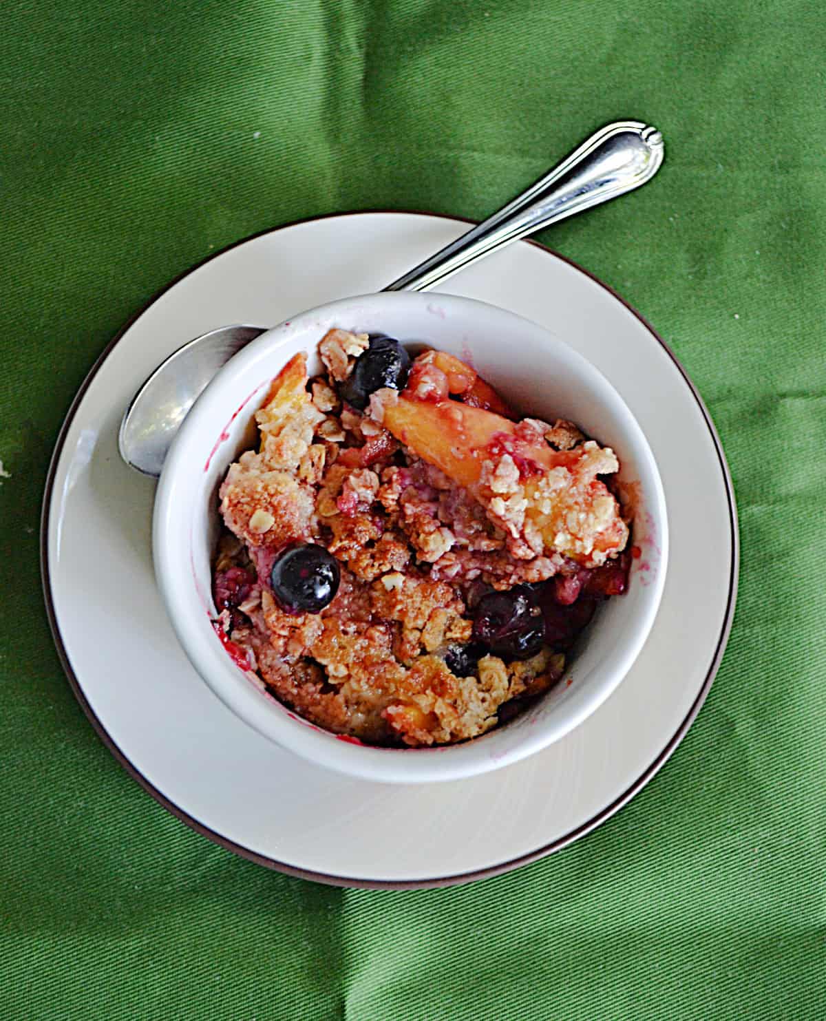 A bowl of peaches and berries.