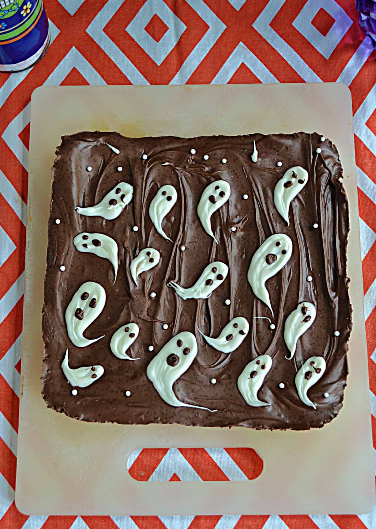 A square of chocolate with white ghosts on top.