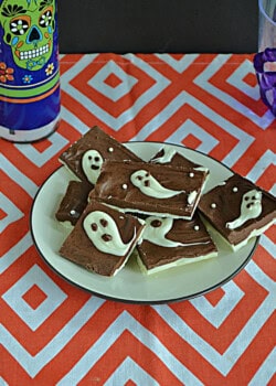 A plate of chocolate with ghosts on top.