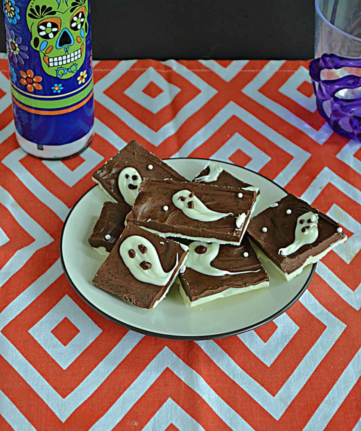 A plate of chocolate with ghosts on top.