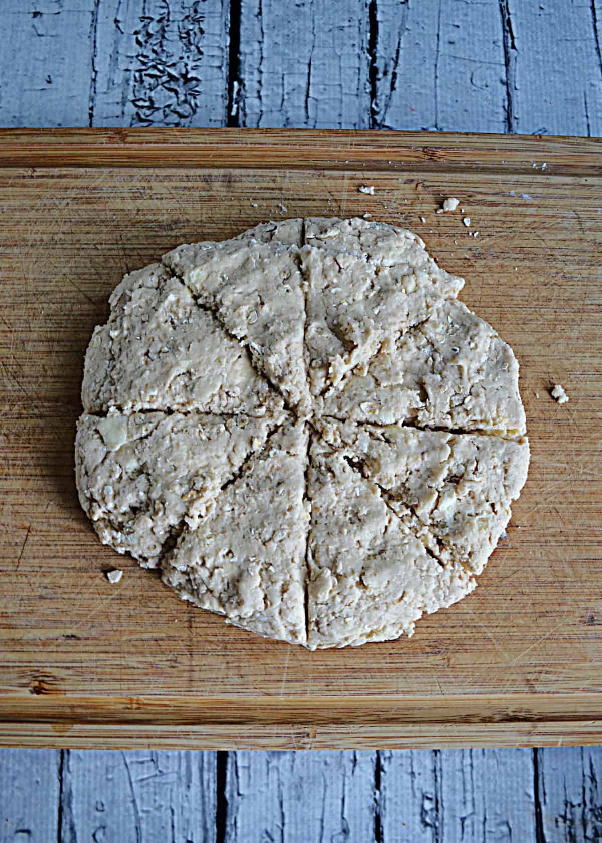 Scone dough shaped into a circle and cut into wedges.