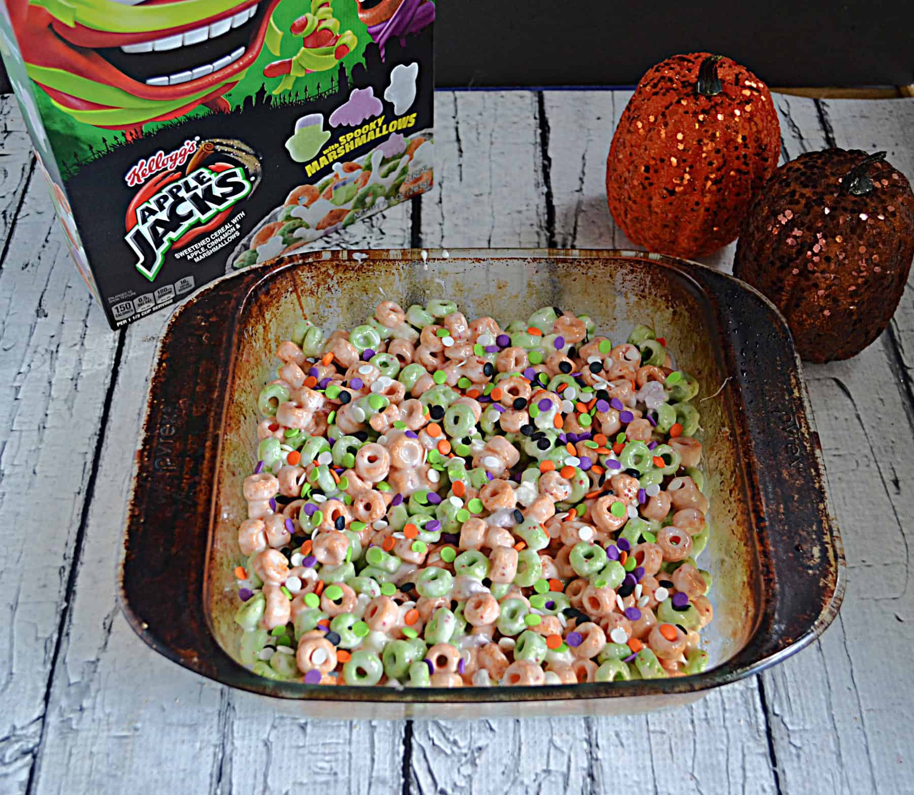 A baking dish of Apple Jacks cereal treats with a box of Apple Jacks.