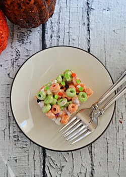 A square of Apple Jacks cereal treats with 2 forks.