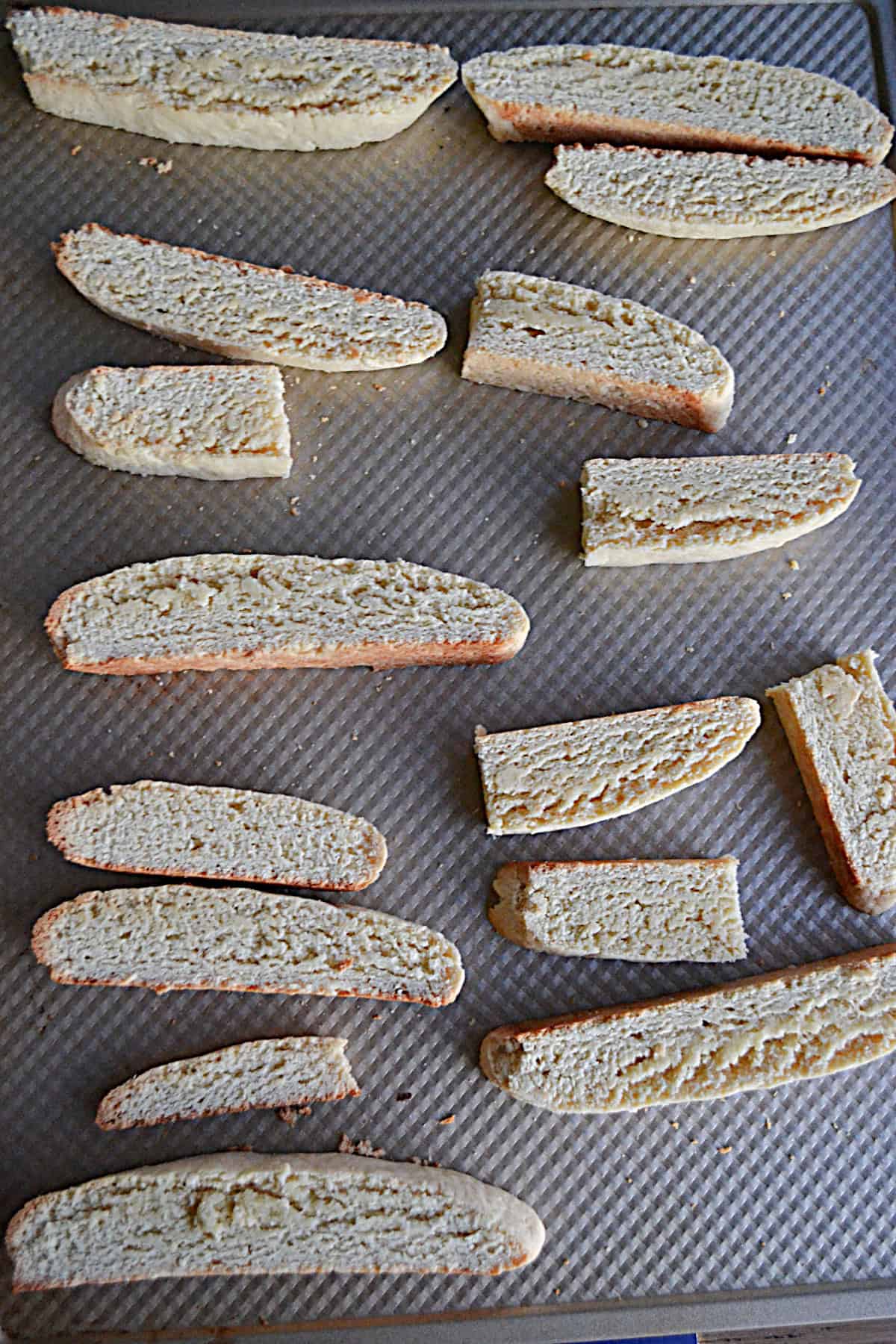 Pieces of biscotti on a baking sheet.