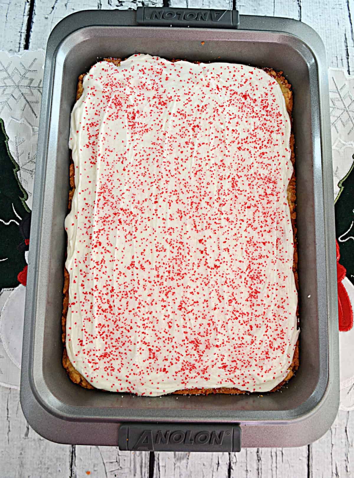A pan of bar cookies with buttercream frosting on top.