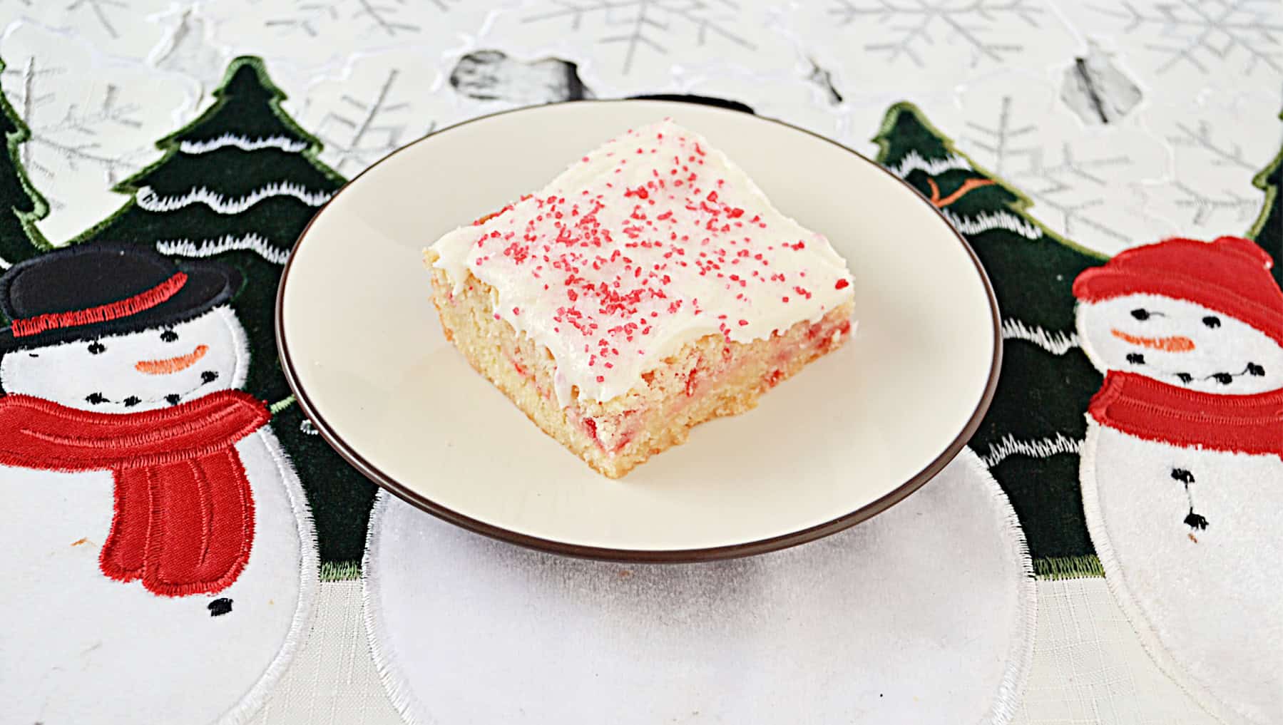 A plate with a sugar cookie bar on it.