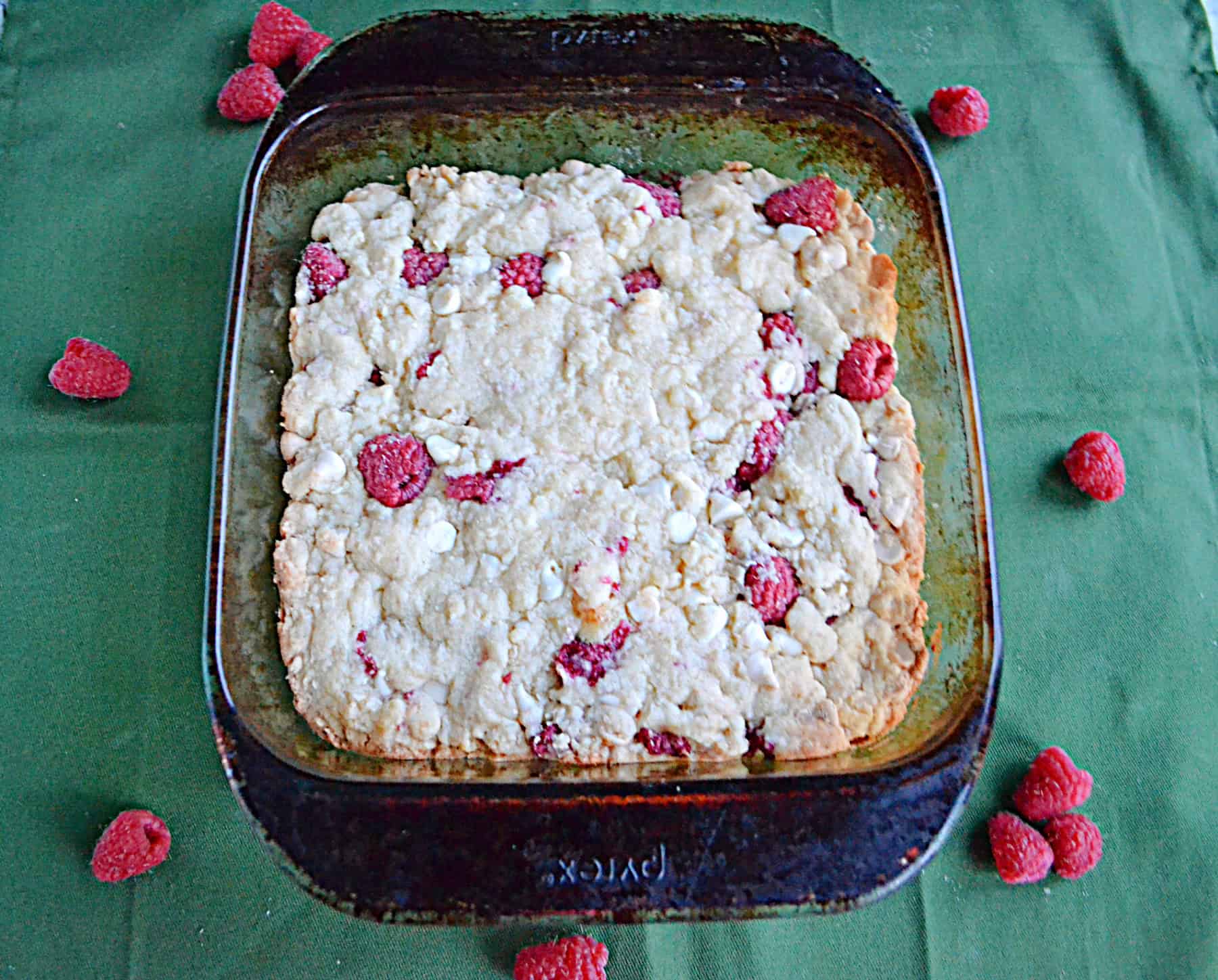 A baking dish with white chocolate raspberry cookies in it.