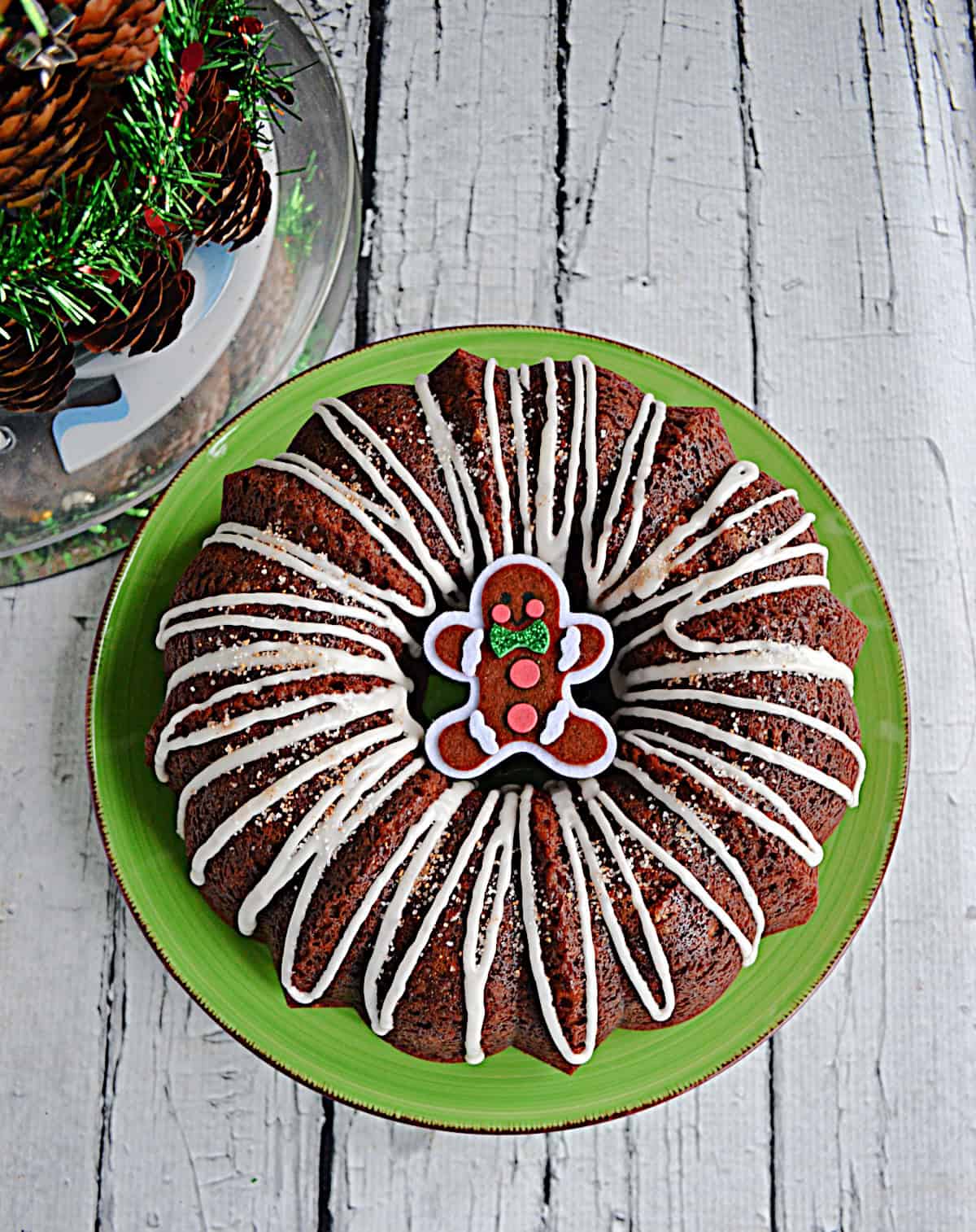 A close up of a Bundt Cake with a gingerbread man in the middle of it.