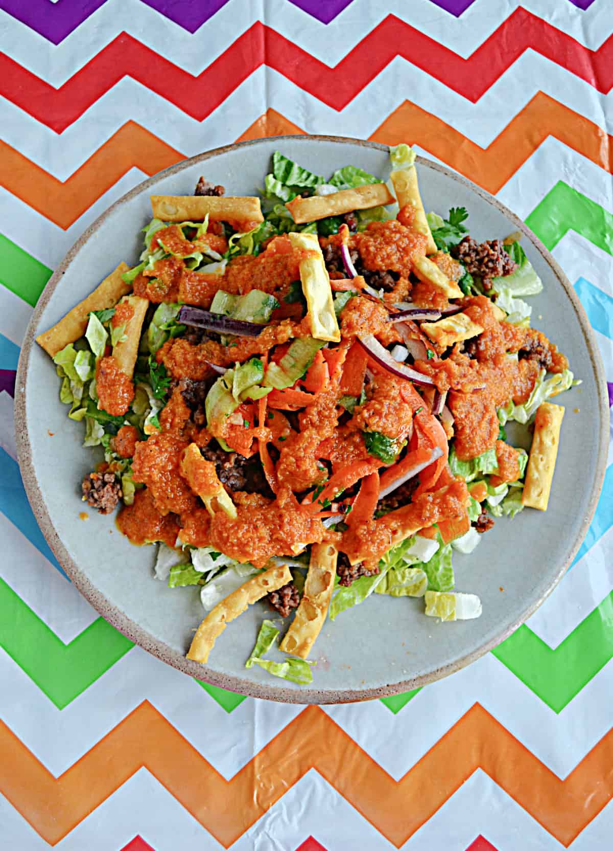 Salad with ground beef, crispy noodles, and carrot ginger dressing.