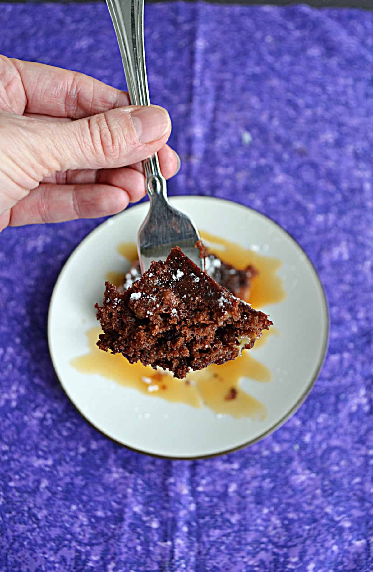 A fork holding a piece of brownie.