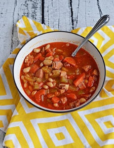 A bowl of soup with a spoon in it.