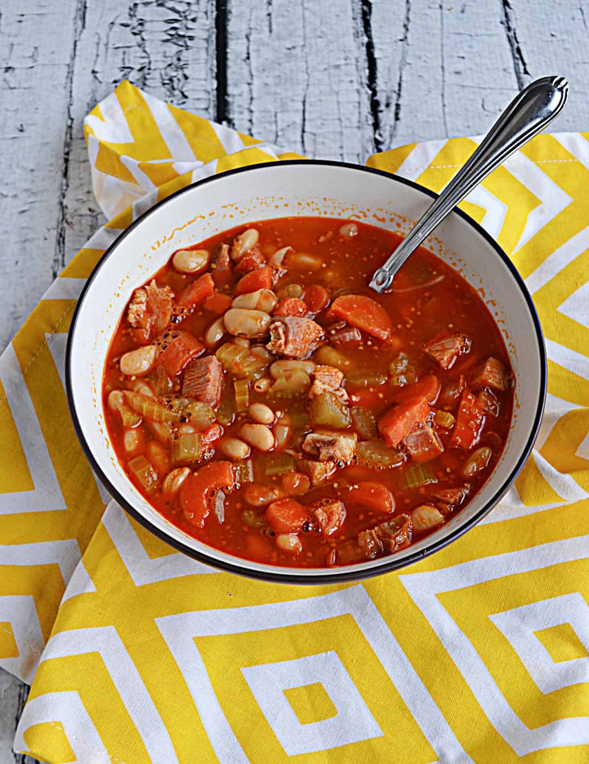 A bowl of soup with a spoon in it.