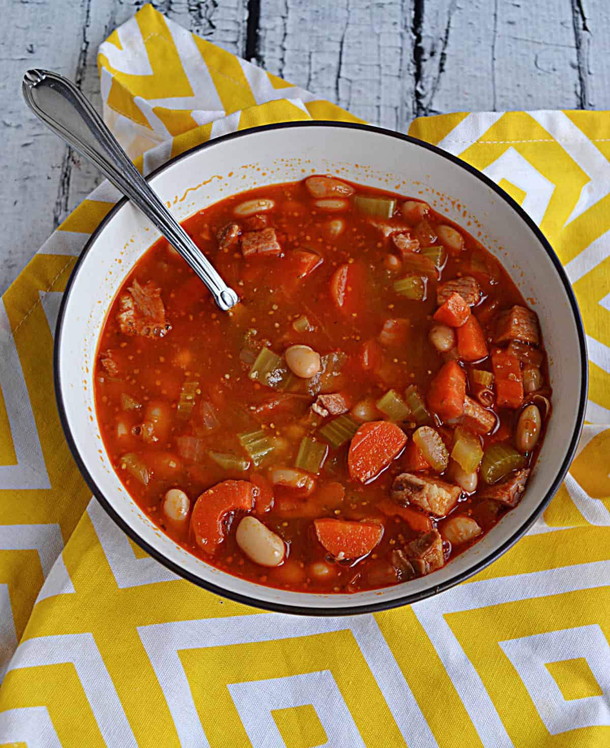 A bowl of soup with a spoon in it.