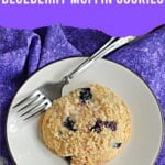 Blueberry muffin cookie on a plate with a fork, text title.