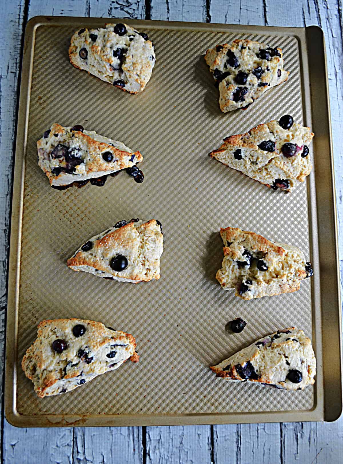 A baking tray with scones on it.