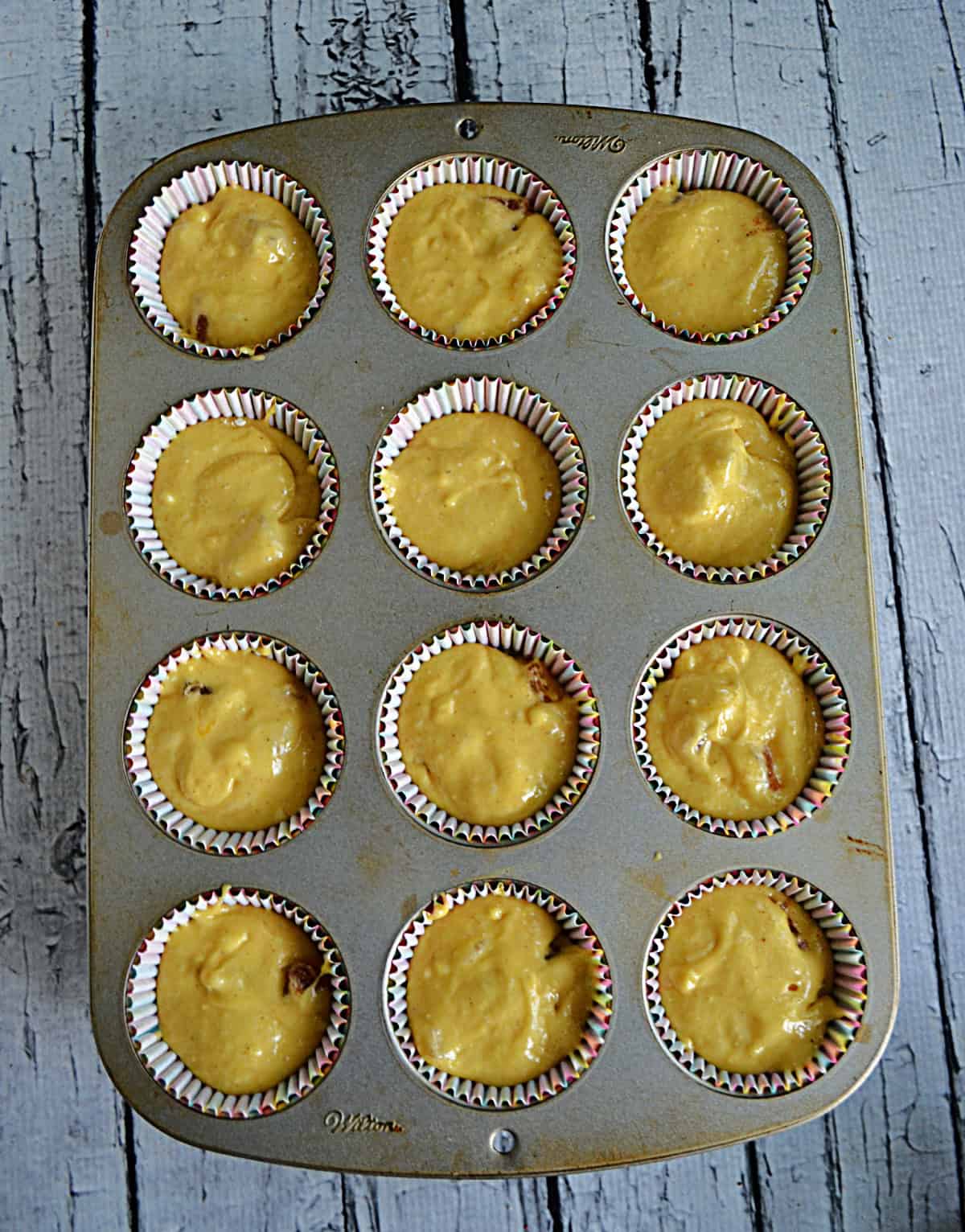 A muffin tin filled with cake batter.