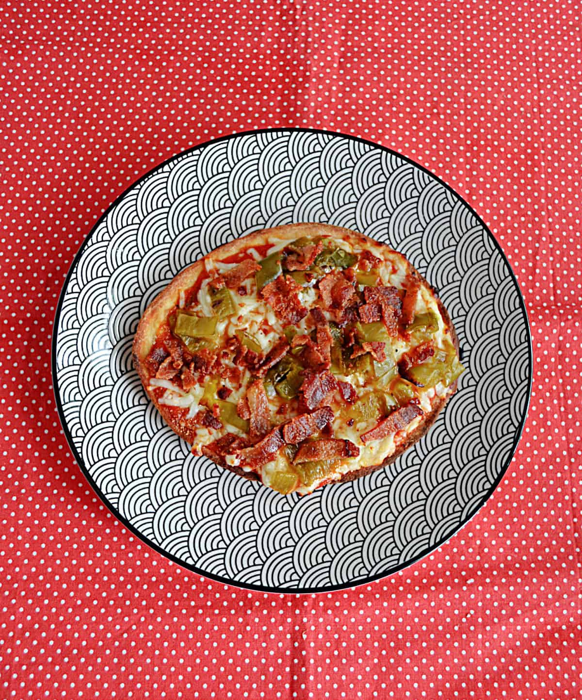 A Naan Pizza on a plate.