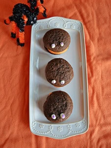 A platter with three chocolate whoopie pies with eyes on them.